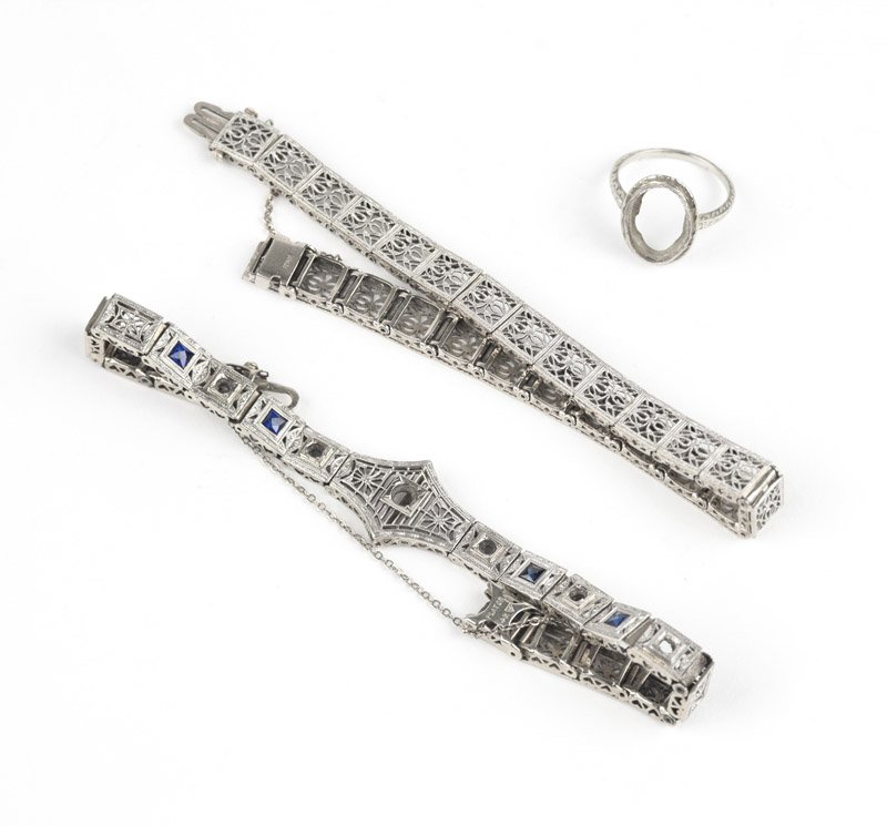 A group of white gold filigree jewelry: Two 14K white gold filigree bracelets, one with synthetic sapphire and diamonds removed and one plain with no gems and an 18K white gold filigree ring mount, 39 gms gross, 3 pcs, est: $350/550
