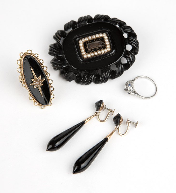 A group of antique jewelry: A 14K gold, black onyx and seed pearl ring, a Victorian memorial brooch of carved jet with seed pearls, a pair of onyx and gold-filled screw-back earrings and one platinum, diamond and sapphire ring m