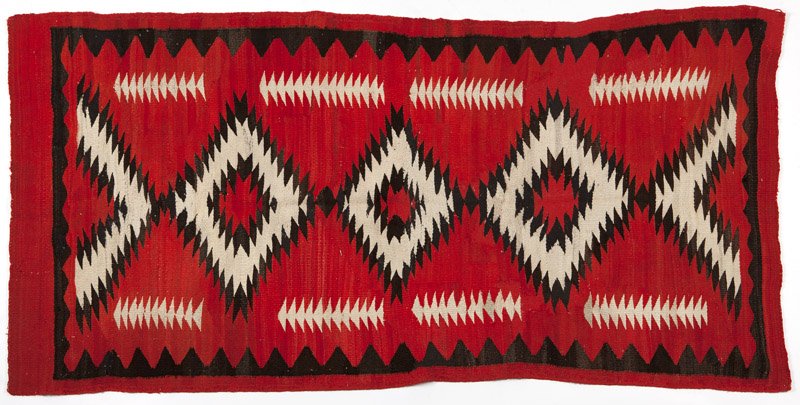 A Navajo Southwest regional rug: Late 19th / early 20th century, red field with central black and white serrated diamond design, 7'11'' H x 4'1.5'' W, est: $800/1000 Provenance: Private collection, Boca Raton, FL