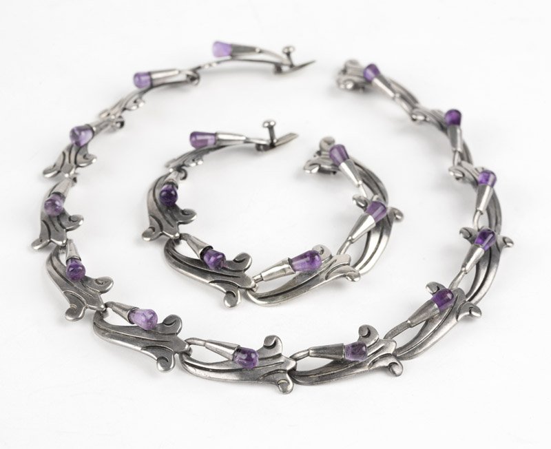 An amethyst floral set, Antonio Reina: Stamped AAR, Hecho en Mexico, 925 Sterling, Taxco, floral wrap sectionals with amethyst tips, together with a matching bracelet, box clasps, 15'' and 6 3/4'', 86.4 gms gross, est: $300/500 Provenance: