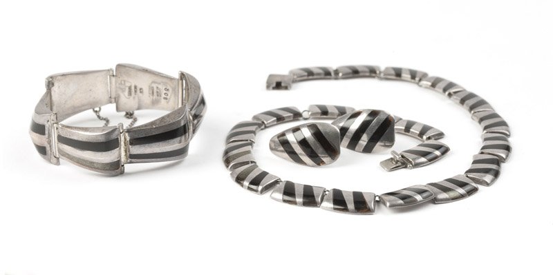 A silver and obsidian suite, Ledesma: Stamped Taxco, Hecho en Mexico, Plateria Cortes, 925, 505, eagle mark 3, name deficient on sterling silver and obsidian inlay necklace, stamped Ledesma, 302 on matching bracelet and 233, eagle mark 3