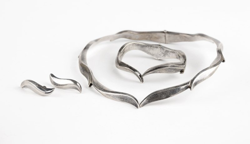 A silver wave set, RIC, for Erika Hult de Corral: Stamped Ric, Taxco, Hecho en Mexico, 925, 195, eagle mark 3, a sterling back hinged collar, a hinged bangle and screw-back earrings in a wave motif, 15 3/4'' and 6 3/4'', 181.7 gms, est: $150/250 Prov