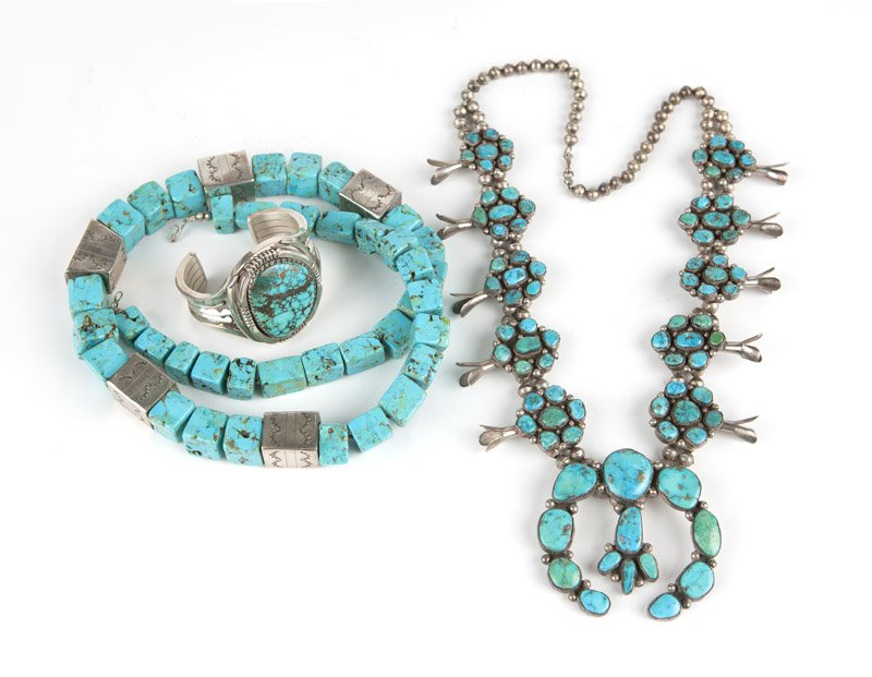 A group of turquoise and silver jewelry: Including a squash blossom necklace, a large cube beaded turquoise and silver necklace and an oversized cuff bangle, 30'' for cubed necklace, 5 1/8'', 3 pcs, est: $600/800