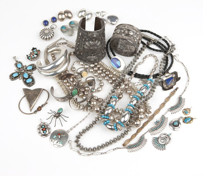 A large group of silver and metal jewelry: Including seven mostly silver beaded necklaces, a wire collar, a silver chain, a silver bead bracelet, a silver cuff, seven silver/metal bracelets/bangles, a bolo, two gold and turquoise pendants, eig