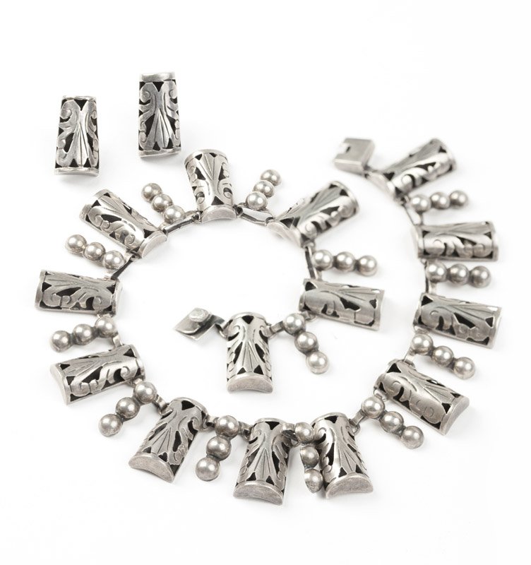 A floral pierced necklace and earrings, E. Barena: Stamped E. Barena, Taxco, Mex, 925, a silver floral hollow pierced necklace with matching screw-back earrings, box clasp, 15 1/4'', 79 gms, est: $200/400 Provenance: Property from a Southern Californi