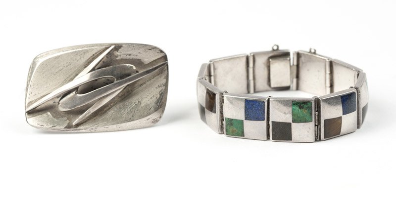 A stone and silver bracelet with a silver brooch: Stamped Los Castillos, Hecho en Mexico, 19, an obsidian, tiger's eye and stone bracelet with a stamped Ledesma, Taxco, Hecho en Mexico, 925 silver brooch, 6 3/4'', 67 gms gross, est: $150/250 Provenan