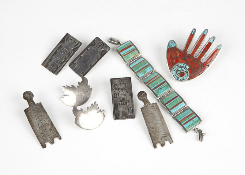 A group of stone and silver jewelry items: Including a stamped MCL coral and turquoise hand motif pendant enhancer/brooch with mother-of-pearl backing, a stamped V. Bennaly sterling square sectional bracelet with turquoise and coral linear inl