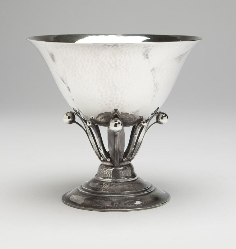 A Georg Jensen sterling silver compote: Circa 1926-1930, designed by Johan Rohde, with maker's mark, further marked ''Sterling'' and ''Denmark'', pattern number 17A, the slightly flared circular bowl raised on foliate supports issuing from