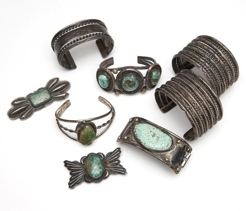 A collection of Native American jewelry: A collection of silver, metal and turquoise jewelry including three plain cuffs, two turquoise-set cuffs, two belt sectionals and one partial metal watch band with turquoise, 8 pieces, est: $500/700