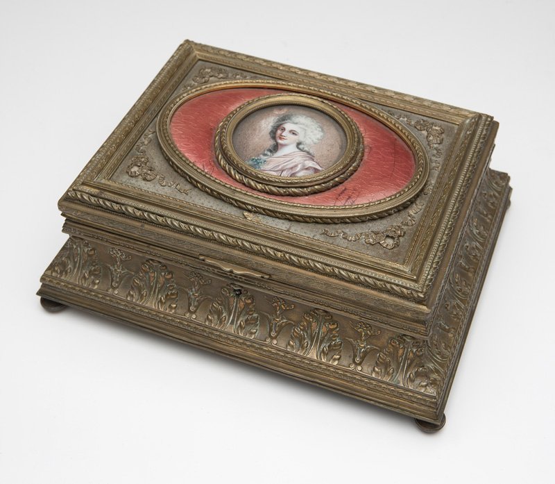 A French gilt-bronze jewelry casket: Late 19th/early 20th century, stamped to underside ''France'', with a fabric tag to interior '''Dollye Holcomb / Couturiere'', surmounted by a hand-painted porcelain portrait medallion of a young beau