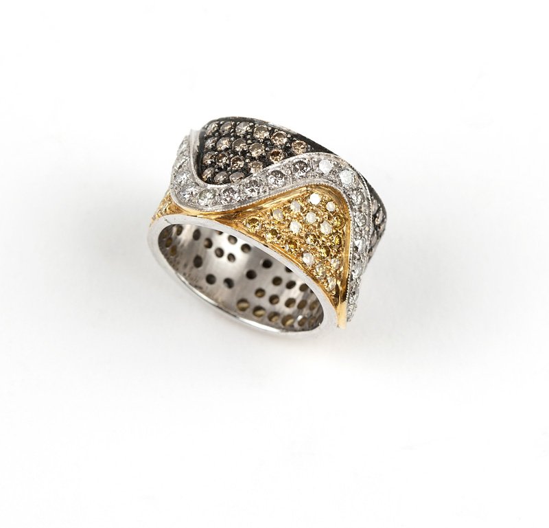 A diamond and colored diamond band: 18K white gold band ring set with 108 colored yellow and light brown full-cut diamond sectionals totaling approximately 1.95 cts., separated by a wave of 36 colorless full-cut diamonds totaling approx