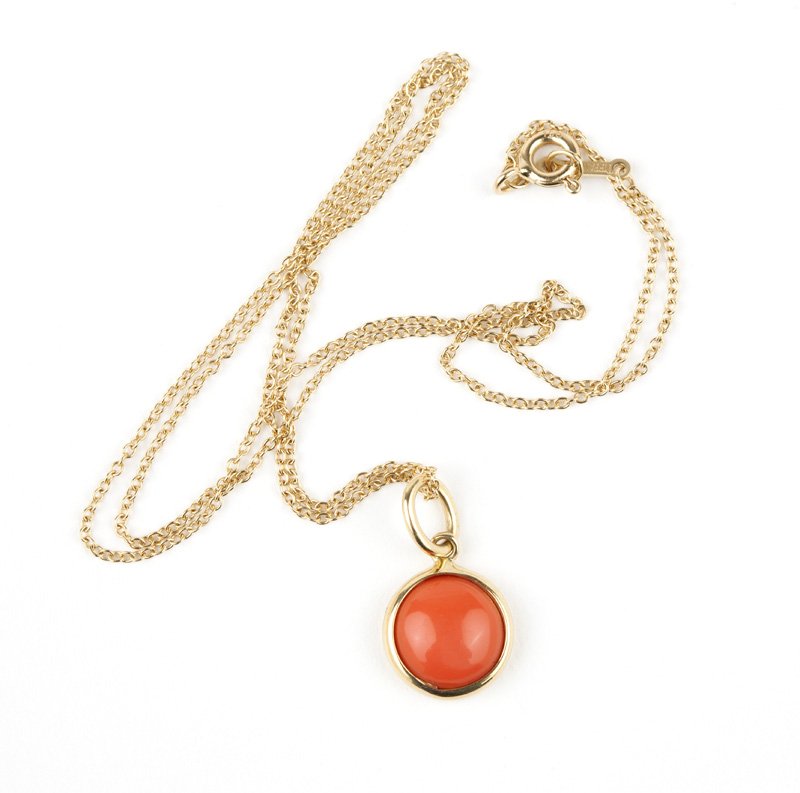 A coral pendant, Paloma Picasso, Tiffany & Co.: Signed Paloma Picasso, T&Co, 750, 18K gold pendant centering a round cabochon coral attached to a signed Paloma Picasso, TIFFANY & CO. 18K gold chain, diameter: 11 mm, chain length: 18'', est: $400/60