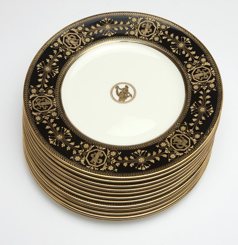 A set of 12 Wedgwood ''Astbury'' dinner plates: Mid-20th century, each with green underglaze maker's mark ''Wedgwood / Bone China / Made in England'' and gilt mark ''W2035'', each circular white ground porcelain plate with a black rim gilt-painted 