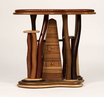 Steven Spiro (20th century- Madison, WI): 2005, hand-carved and inlaid lamp table, with a stepped freeform top inlaid with a fossil, a mother-of-pearl button and various woods in abstract motifs and moon phases, raised on a tall pyramidal sta