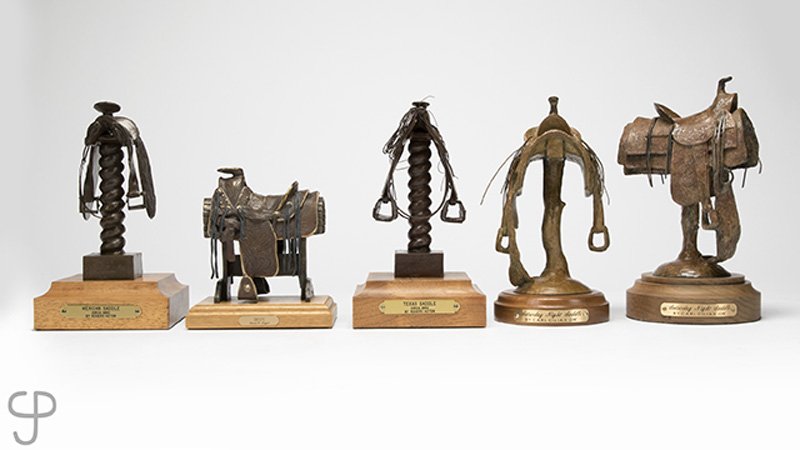 Group of five miniature bronze saddles, various artists (1 of 6)