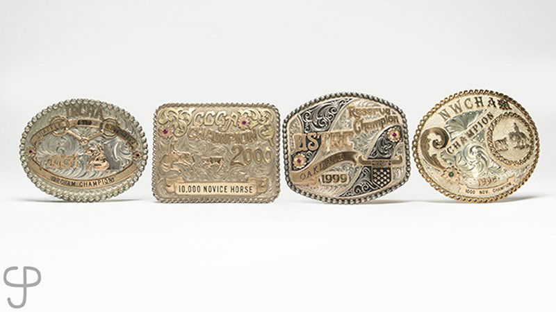A group of four large belt buckles (1 of 2)