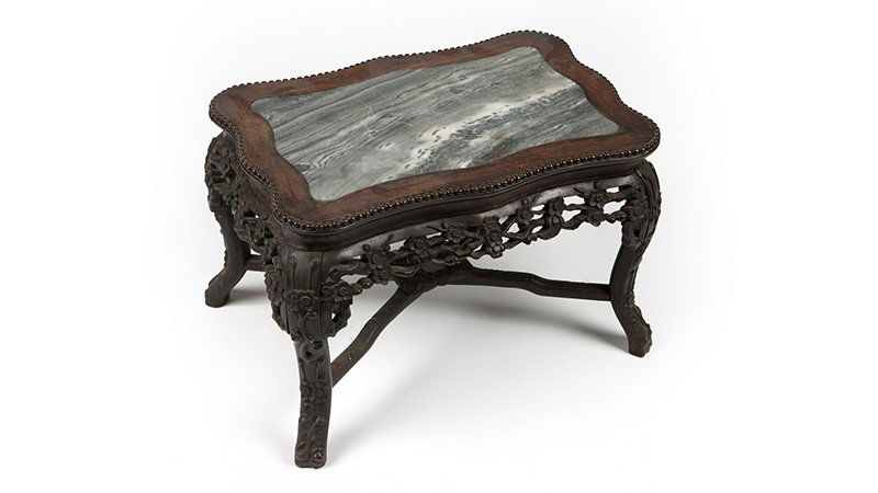 A Chinese export carved hardwood occasional table (1 of 2)