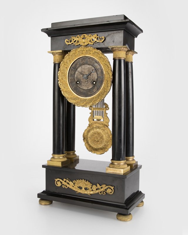 A French Empire-style portico clock: Early 20th century, the two-train movement apparently unsigned, stamped ''102'', pendulum lightly stamped ''TJ'' and ''102'', with a squared cornice over a gilt bronze-mounted frieze raised on four Eg