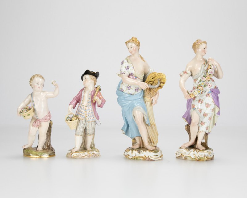 A group of four Meissen porcelain figures: Late 19th/early 20th century, each with blue underglaze crossed swords mark, the first: further inscribed ''C84'', a semi-nude standing female figure holding a garland of roses, allegorical figure of
