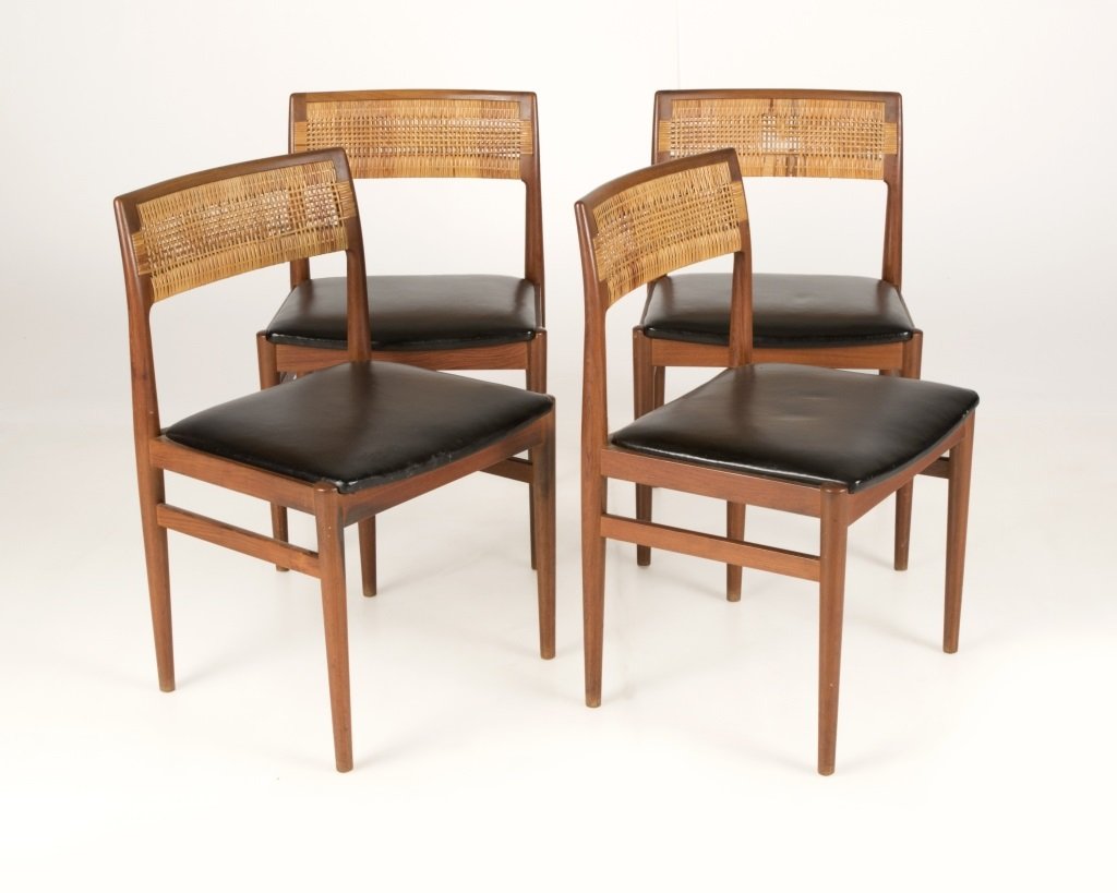 Four Erik Worts W26 side chairs: Mid-20th century, Danish, designed 1957 by Erik Worts for Henrik Worts Mobelfabrik, each teak frame with a caned back rest and a black leather seat, raised on tapering cylindrical legs, 4 pieces, each