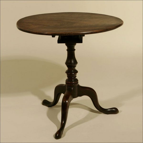A GEORGE III MAHOGANY TRIPOD TABLE: Second half 18th century, the circular top tilting above a baluster-turned stem over cabriole legs ending in tapering pad feet, with printed paper label to top of birdcage Michael Davis: 27.5" x 28"