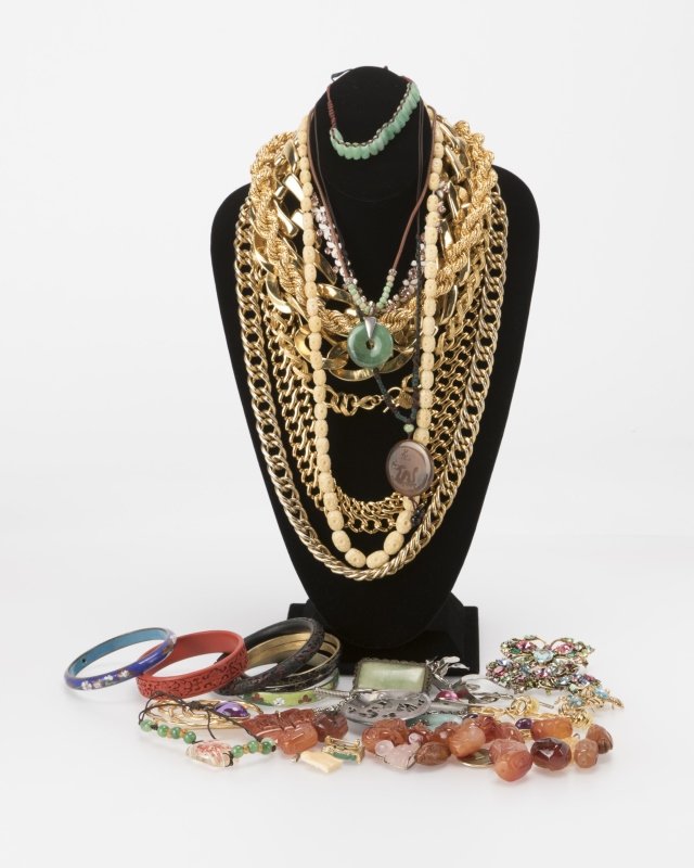 A group of silver and costume jewelry: Including one circular silver pendant signed, Coro; six various metal and laquer Chinese bangles; six gold-toned metal necklaces; seven various costume brooches; two costume necklaces; a pair of costu