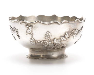 A Chinese silver bowl, Sing Fat: Early 20th century, Canton, with maker's marks, the circular bowl with a scalloped rim over a body relief-decorated with birds and flowering cherry branches, on a scalloped spreading foot, 3'' H x 6''