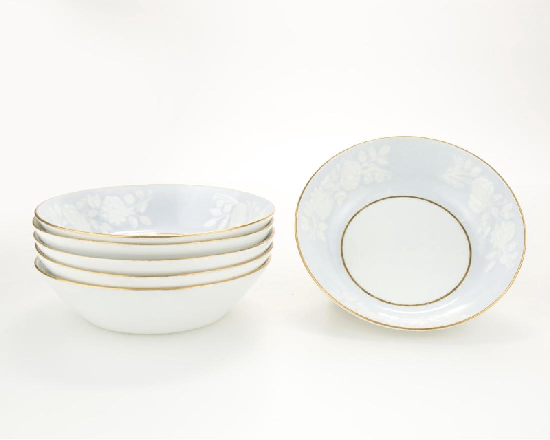 Six Russian porcelain soup bowls: Early 20th century, each white ground with raised floral decoration on a gilt powder blue-ground rim, 6 pieces, each: 1.75'' H x 6.625'' Dia., est: $200/300 Provenance: Private Collection, Los Angeles