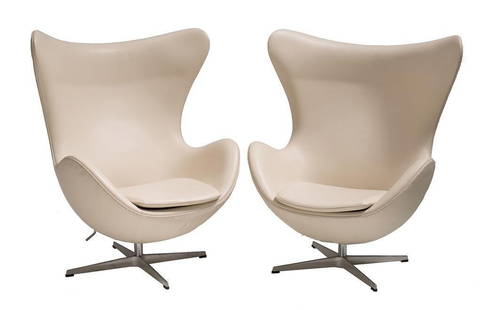 Two Arne Jacobsen Leather Egg Chairs: Two Arne Jacobsen Egg chairs with leather upholstery and chrome bases, 38.5 x 34.5 x 35" From the Estate of Linda Pace