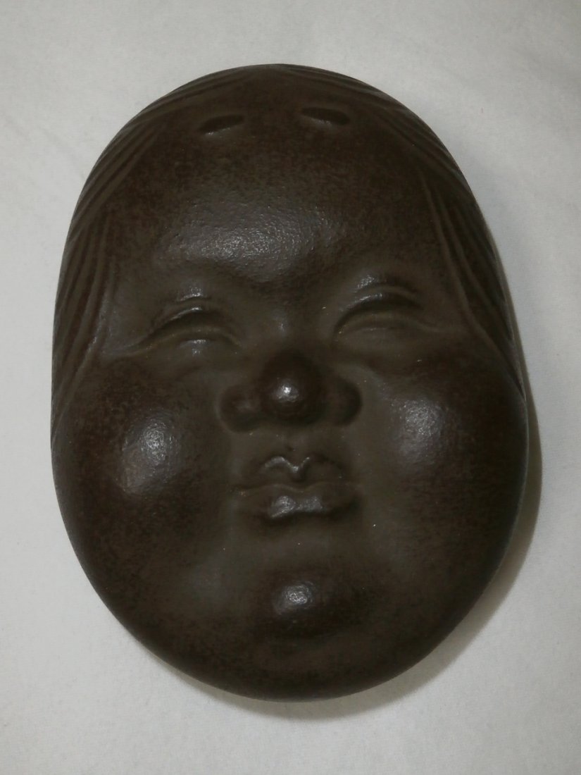 Cast Iron Otafuku Incense Box: The Abundant and Serene Face of Otafuku, who's name literally means "Much Good Fortune” in Japanese, was lovingly created for this rare and wonderful cast iron incense box. Otafuku is revered in Jap