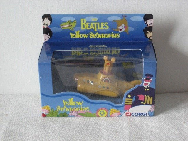 Beatles 1999 Corgi model figure The Yellow Submarine: Beatles figurine of the Yellow Submarine in its original 1999 box. It is a metal toy model with a moving propeller and wheels. The box is in mint condition with some . Cool in any Beatles collection !