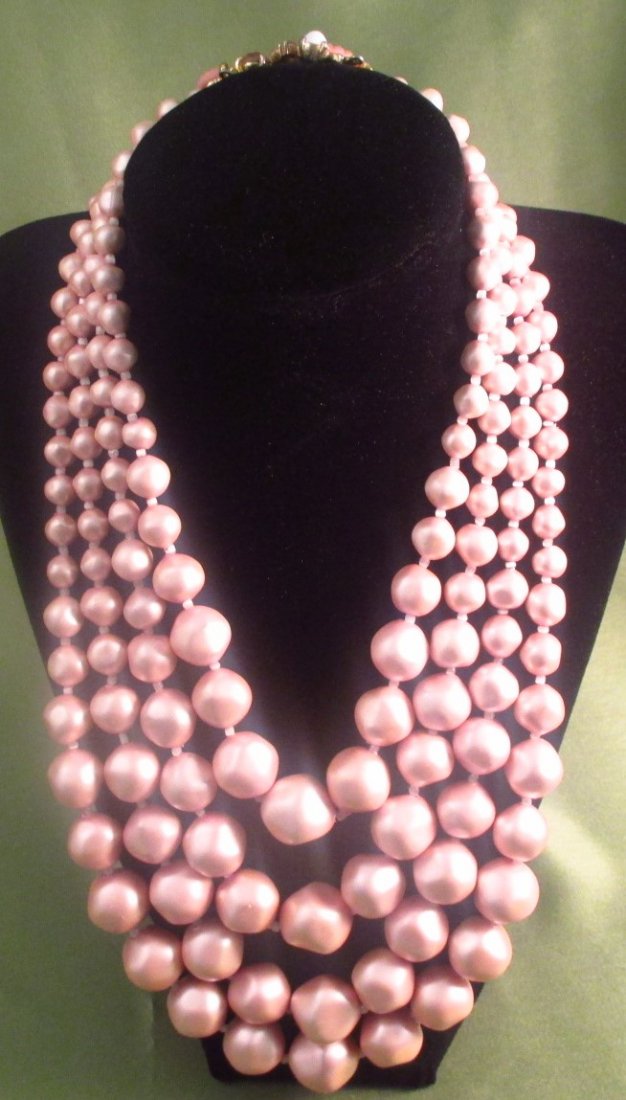 Schiaparelli Pink Faux Pearl Necklace: Schiaparelli Signature Pink Graduated Baroque Faux Pearl Necklace. Marked Schiaparelli and is 16" long at the shortest strand and 20" at the longest strand.