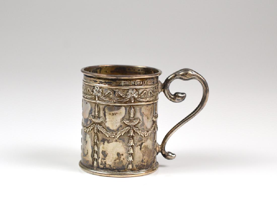 ENGLISH SILVER CHRISTENING MUG: With sway and ribbon decoration, Birmingham marker L&S. H. 6.5 cm(2 1/2 in.) W. 44g.