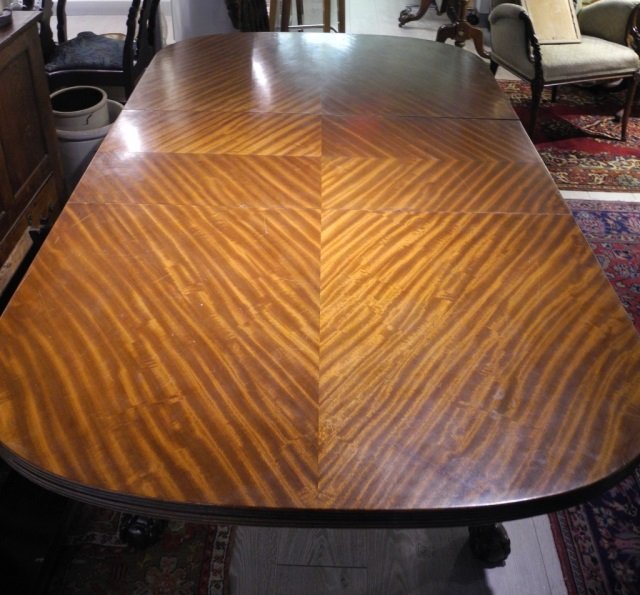 Mahogany dining table on ball and claw feet: with one leaf measuring 18 in. \r\n30 1/4 in. x 64 in. x 41 3/4 in.