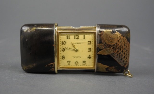 MOVADO SILVER & GOLD JAPANESE LACQUERED WATCH: Movado, Ermeto 9 karat gold and silver sliding pillow purse watch with ivory face and Arabic numerals.