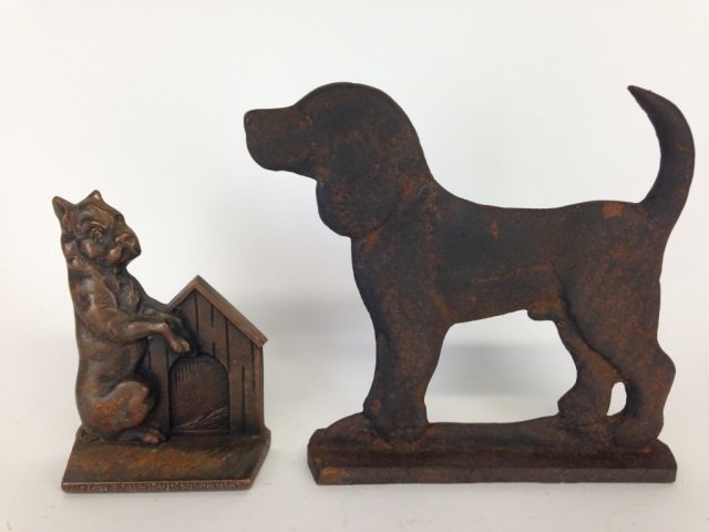 TWO ANTIQUE CAST IRON DOORSTOPS: Two dog figural door stops, one signed Verona. H of tallest: 24 cm. (9.5 in.)