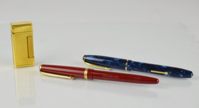 DUNHILL LIGHTER & CONWAY STEWART PENS W/ GOLD NIBS: Lighter with engine turned body and cylindrical column form striker. Burgundy fountain pen #103 with 14K gold nib & Blue marbled fountain #15 with 14K gold nib.