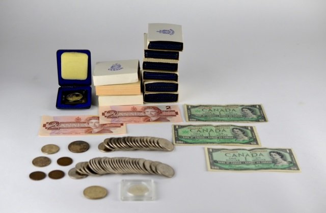 COLLECTION OF CANADIAN COINS & CURRENCY: Including 24 1873/1973 Prince Edward Island Commemorative dollars, 2 two dollar bills, 3 one dollar bills,1961 & 1965 silver dollars, 2 1968 silver dollars, 2 1972 dollars, 27 1971 British Columbia co