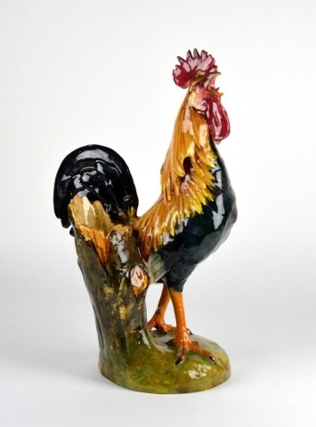 MAJOLICA JEROME MASSIER ROOSTER FIGURAL VASE: Vallauris, France, late 19th century. Modelled standing next to a cylindrical wheat sheaf vase. Stamped base. H: 44.5 cm. (17 1/2 in.). Small repair, two flakes.