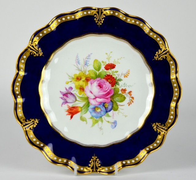 ROYAL CROWN DERBY PORCELAIN CABINET PLATE: With central hand painted floral spray and enamelled and gilt border, signed Albert Gregory . Impressed Derby. Date cypher 1927.D: 8 3/4 in. (22 cm.) Good condition.