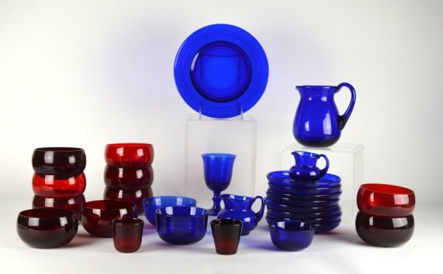 COLLECTION OF HOLMGAARD GLASS: Lot of assorted Scandinavian glass includes 26 pieces of cobalt and red glass. Jug, sugar and creamer sets, dishes, bowls in various sizes and stem.