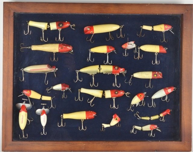 COLLECTION OF VINTAGE FISHING LURES: Consisting of 21 wooden lures total in display case including Southbend, ucky Strike, Hex, Heddon, Jitter Bug, Clark, Water Scout, Creek Chub, L & S, etc.