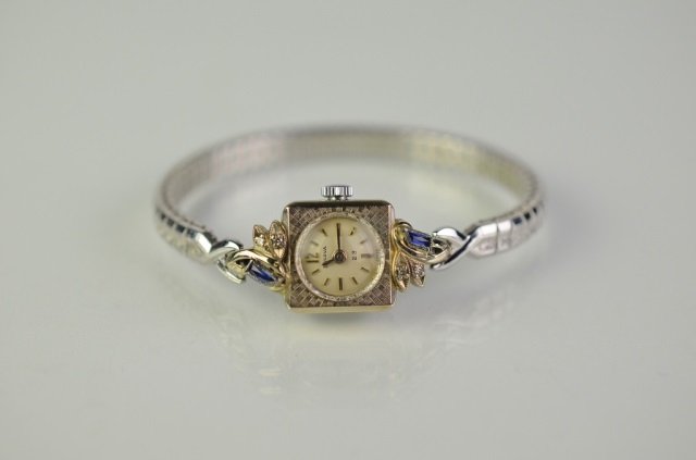 LADY'S BULOVA WRIST WATCH: Art Deco style10k rolled gold face set with blue stones.