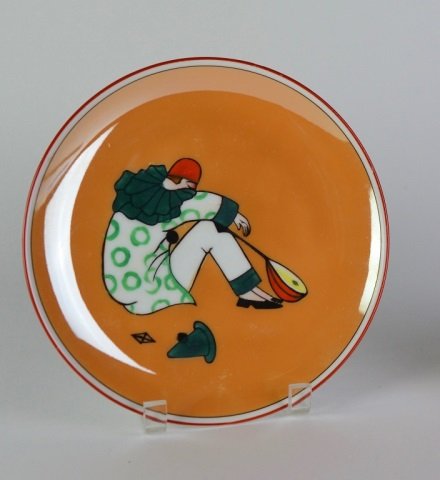 ART DECO NORITAKE DISH: In caramel lustre ground central clown figure. D: 22 cm.(8 13/4 in.)