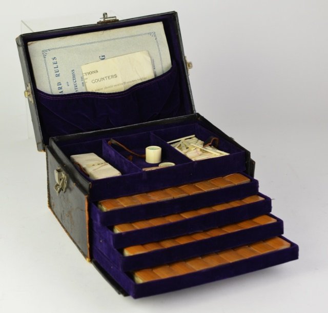 CHINESE CASED BONE & BAMBOO MAH JONG SET: 144 piece set in fitted leather case. Comes with four extra pieces, counters, pair of dice, markers, instruction manual & key for locking case.