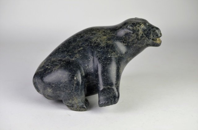 LARGE INUIT SOAPSTONE CARVING OF A BEAR: LARGE INUIT SOAPSTONE CARVING OF A BEAR Mottled dark green carving signed in syllabics & dated 78. L: 10 in.