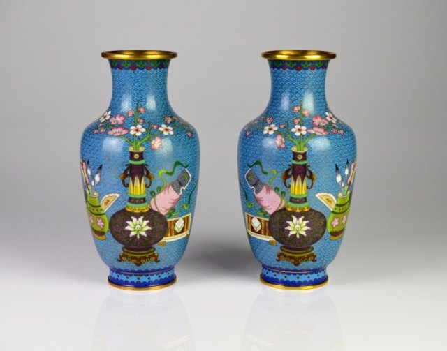 PAIR OF CHINESE CLOISONNE VASES: Decorated with antiques, cherry blossoms and peaches. With scrolled wire work on robins egg blue ground, 20th century. H: 10 in. (25.5 cm).