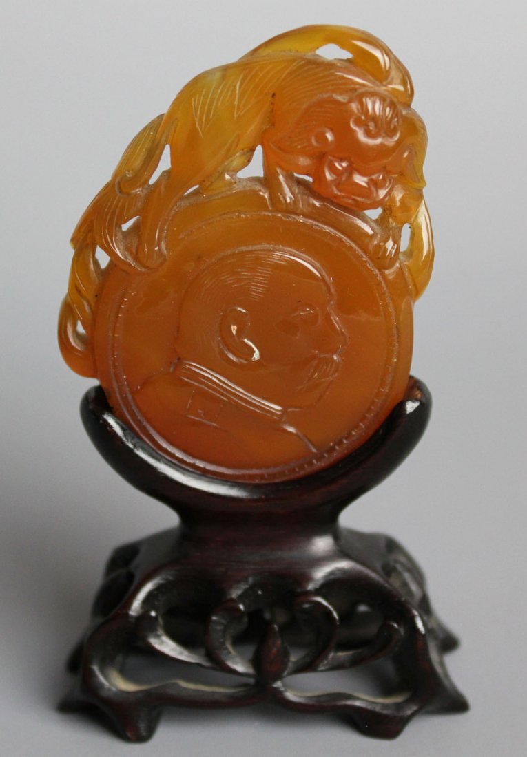 An Chinese agate carving on wooden stand: An Chinese agate carving on wooden stand, Yun Shikai on one side, Republic period, no other example of this type is recorded, hence very rare. Estate of major Roy Dasen Carving hight: 5.5cm(2in)