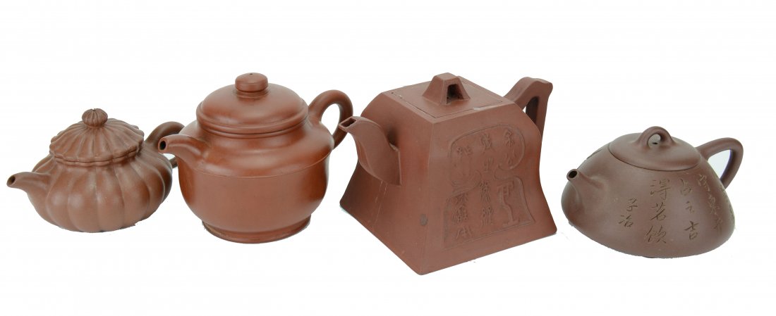 A Collection of Chinese Yixing Teapots. Late Qing to: Comprised of four Yixing purple clay teapots in various shapes and size, all with potter's mark under the base. Two with plain exterior walls while one has lobed wall and the other with incised bamboo