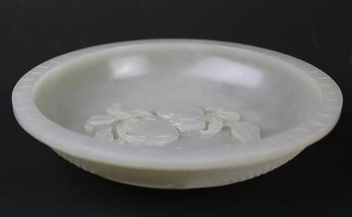 A Large Chinese Carved Jade Peach Bowl. Qing Dynasty: Carved from a single block of very pale celadon nephrite jade of even tone into an elegant shape with slope walls and wide rim rested on low flat footring, perhaps intended for the scholar table. The